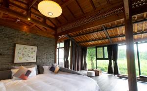 Postel nebo postele na pokoji v ubytování Alina Garden Boutique Resort Huangshan Hongcun + 37 fotografií