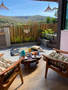 a patio with a table and chairs and a view at Loft Mandalua in Serra do Cipo