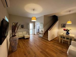 a living room with a staircase and a living room with a table at Villa Sissi in Bari
