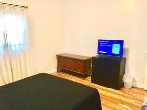een slaapkamer met een bed en een televisie op een dressoir bij Homey 2 bedroom Apartment, Minutes from Everything! in Minneapolis