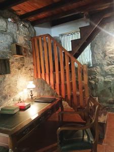a wooden desk with a chair and a staircase at Molino cascada de caldas de reyes in Caldas de Reis