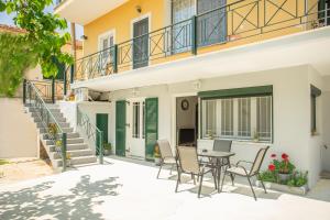a patio with a table and chairs in front of a house at GIANΝS HOME in Marantochori