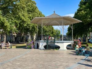 a pavilion with people sitting in chairs in a park at Hector Zierikzee in Zierikzee