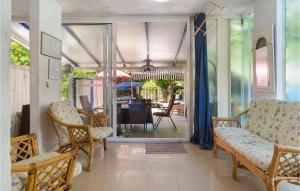 a living room with chairs and a dining room at Holiday Home Sucuraj 06 in Sućuraj