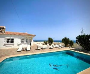 a swimming pool in front of a house at Villa turística Sol y Mar in Mijas