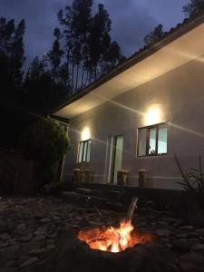 a fire pit in front of a house at night at Casa I Love Huaraz in Huaraz