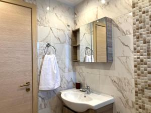 bagno con lavandino e specchio di Zilean apartments by Airstay a Spata