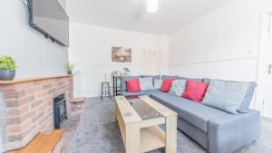 a living room with a couch and a fireplace at Spacious 2 Bedroom Apartment in Barrow in Furness