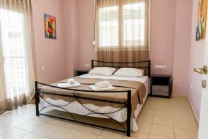 a bedroom with a bed with two towels on it at Aktia Apartments, Preveza in Preveza