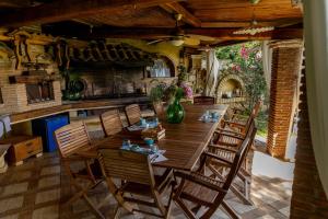 a dining room with a large wooden table and chairs at Cavalieri B&B in San Felice Circeo