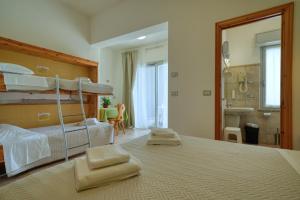 a bedroom with a bunk bed and a bathroom at Camere da Mirella in Lazise