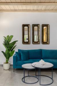 a living room with a blue couch and a table at Margazi Areopolis Luxury Rooms in Areopolis +42 photos