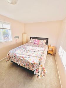 a bedroom with a bed with a comforter and pillows at Hathaway a family home in Corvallis