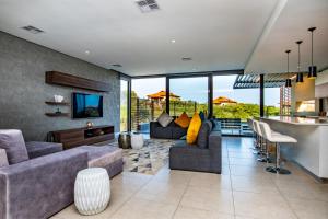 a living room with a couch and a bar at Oceans Edge 5, Zimbali Estate in Ballito