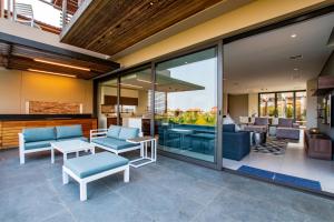 a living room with glass doors and a patio at Oceans Edge 5, Zimbali Estate in Ballito