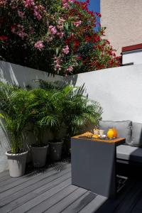 a table with oranges on it on a patio with plants at Miracolo di Mare Golden House in Piran