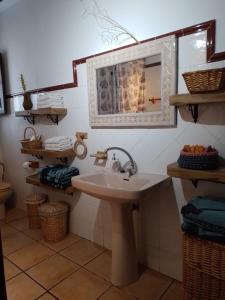 a bathroom with a sink and a mirror at Casas Amaro in Órgiva