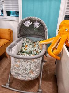 a baby crib with a stuffed elephant on it at Aquarium Exclusive Loft - Free Parking in Genoa
