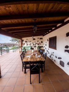 a dining room with a wooden table and chairs at Finca Los Ángeles in Trapiche