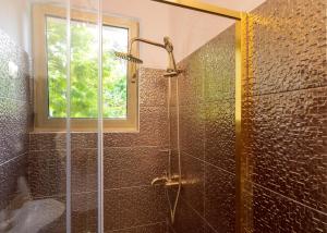 a bathroom with a glass shower with a window at Apartments Villa Domus Marini in Hvar +77 photos