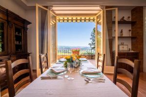 a dining room table with a view of a window at Il Castellaro Country House in Perugia