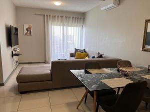 a living room with a couch and a table at D's Central Hideout in Windhoek