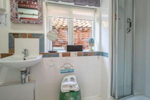 a bathroom with a sink and a shower at Alec Hill's Bakehouse in Wangford