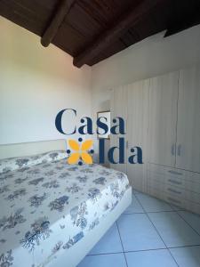 a bedroom with a bed with a csa logo on it at Amalfi Coast Casa Ida in Vietri sul Mare
