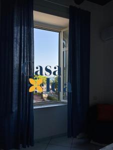 a window with a view of an asia sign on it at Amalfi Coast Casa Ida in Vietri sul Mare