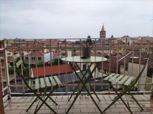 a table and chairs on a balcony with a view at RaMaya, casa d'artista in Biella