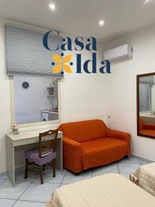 a room with a couch and a sign on the wall at Amalfi Coast Casa Ida in Vietri sul Mare