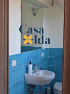 a bathroom with a sink and a sign that reads casa indiana at Amalfi Coast Casa Ida in Vietri sul Mare