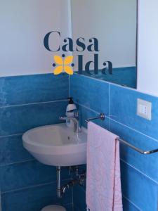 a bathroom with a sink and a sign on the wall at Amalfi Coast Casa Ida in Vietri sul Mare