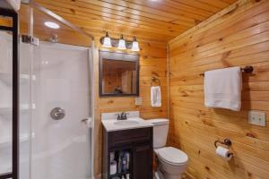 a bathroom with a toilet and a sink and a shower at Higden Hideaway with Fire Pit Near Greers Ferry Lake in Fairfield Bay