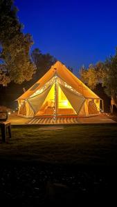 a large tent is lit up at night at ELIES TINY GLAMPING in Ayvalık