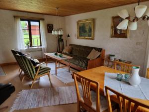 a living room with a couch and a table at Slättö 17 Lammhult in Lammhult