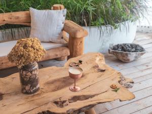 a wooden table with a wine glass on top of it at Flamingo Hotel & Spa - Pet Friendly in Oludeniz