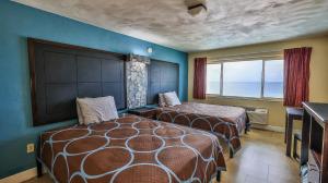 a hotel room with two beds and a window at Driftwood Beach Motel in Ormond Beach +186 photos