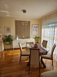 a living room with a dining room table and chairs at Magic Eden Rijeka in Rijeka