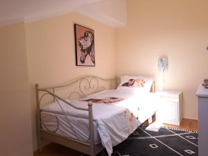 a bedroom with a bed and a picture on the wall at Magic Eden Rijeka in Rijeka