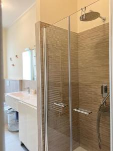 een glazen douche in een badkamer met een wastafel bij Stella house in La Spezia