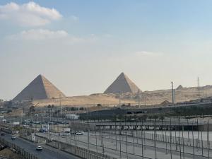 a view of the pyramids of giza and a freeway at Royal Great Pyramid INN in Cairo