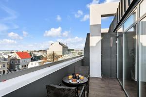a balcony with a table and chairs with a view at ALVA Apartments in Reykjavík
