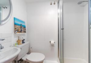 a bathroom with a toilet and a sink and a shower at On the Water 4 with Free Parking By My Getaways in Brighton & Hove