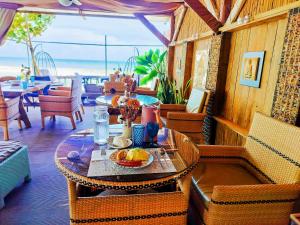 a table with a plate of food on a patio at Swakihan Guest House in Siquijor