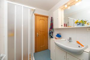 a bathroom with a sink and a shower at Sport & natura in Trentino! in Vigo di Fassa