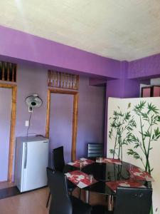 a dining room with a table and a purple wall at Budget Friendly Apartment 2rms in Baguio