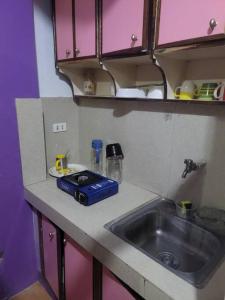 a kitchen with a sink and a counter top at Budget Friendly Apartment 2rms in Baguio