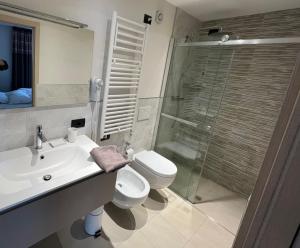 a bathroom with a sink and a toilet and a shower at Appartamenti Mottini Plaza in Livigno +20 photos