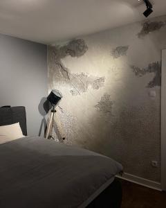 a bedroom with a painting on the wall at Šantić in Novi Sad
